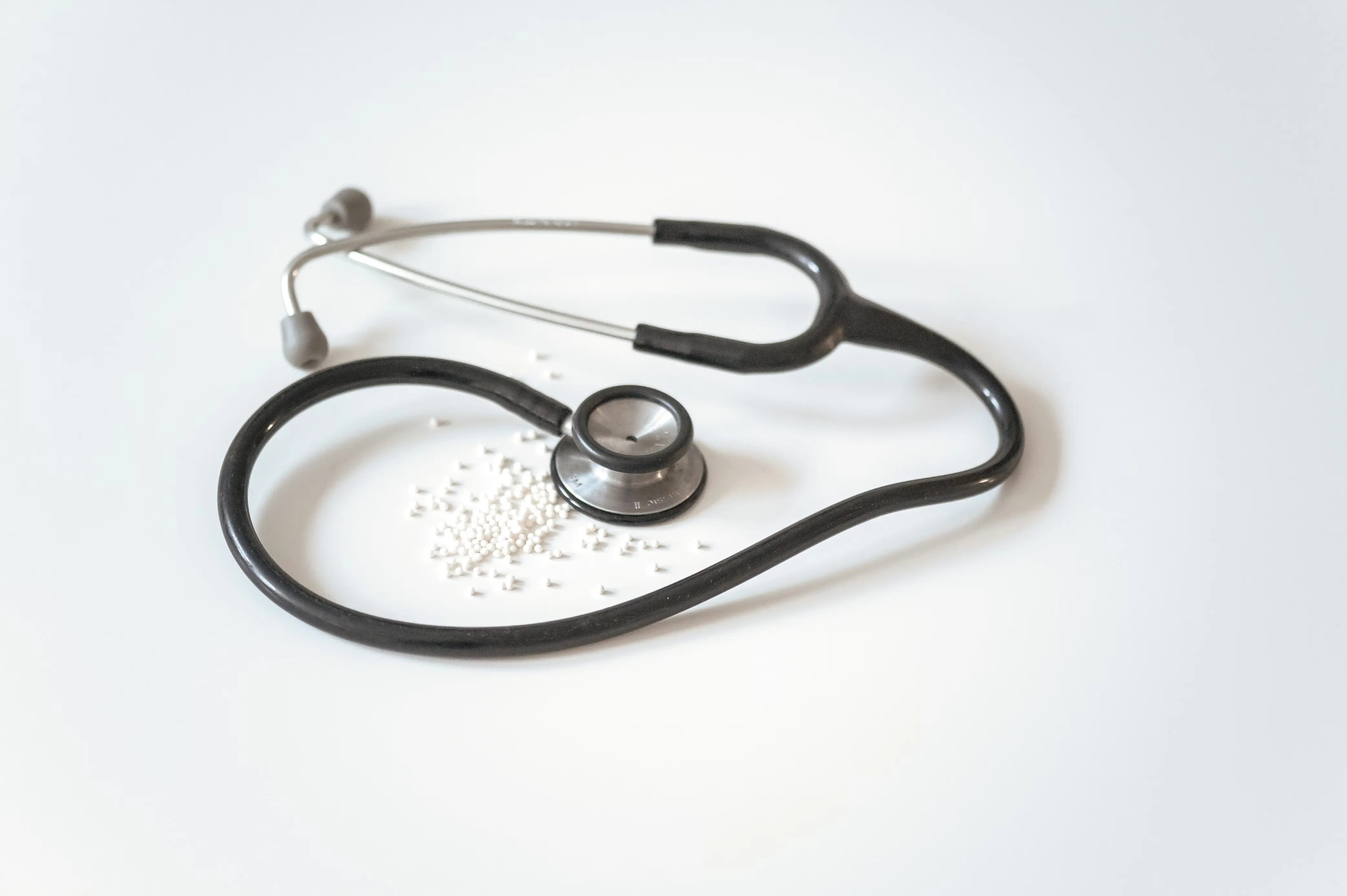 A stethoscope resting on a clinical workspace